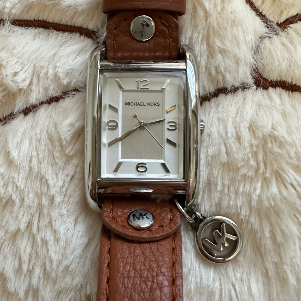Michael Kors Silver Dial with Tan Leather Strap Watch MK charm attached.